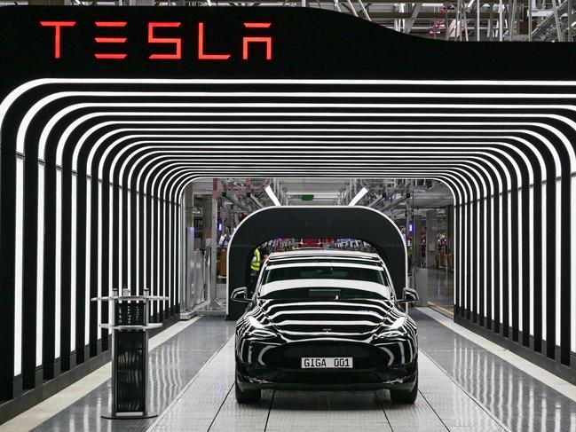 (FILES) An electric vehicle of the model Y is pictured during the start of the production at Tesla's "Gigafactory" on March 22, 2022 in Gruenheide, southeast of Berlin. Tesla confirmed plans on July 18, 2023 to drastically expand its factory near Berlin, with the goal of doubling production capacity at its only European plant to a million electric vehicles per year. The US company said it had filed an application for the expansion of the Gruenheide site with the regional environment ministry of Brandenburg state. (Photo by Patrick Pleul / POOL / AFP)