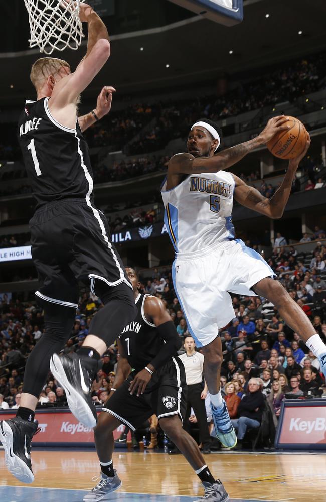 Denver Nuggets forward Will Barton, right, drives the lane for a shot past Brooklyn Nets forward Joe Johnson.