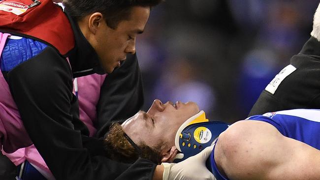 North Melbourne forward Ben Brown is treated for concussion. Picture: AAP