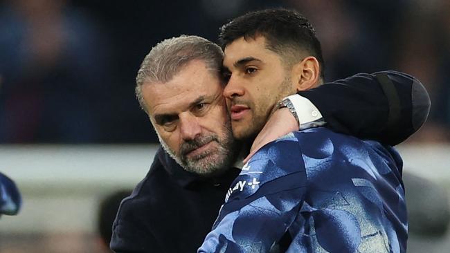 Tottenham Hotspur's Greek-Australian Head Coach Ange Postecoglou (L) celebrates with Tottenham Hotspur's Argentinian defender #17 Cristian Romero (R) on the pitch after the English Premier League football match between Tottenham Hotspur and Aston Villa at the Tottenham Hotspur Stadium in London, on November 3, 2024. Spurs won the game 4-1. (Photo by Adrian Dennis / AFP) / RESTRICTED TO EDITORIAL USE. No use with unauthorized audio, video, data, fixture lists, club/league logos or 'live' services. Online in-match use limited to 120 images. An additional 40 images may be used in extra time. No video emulation. Social media in-match use limited to 120 images. An additional 40 images may be used in extra time. No use in betting publications, games or single club/league/player publications. /