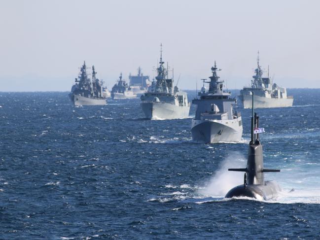 Submarine HMAS Farncomb sails with Navy ships from around the Indo Pacific region during the Japan Maritime Self-Defense Force's International Fleet Review 2022 off Yokosuka, Japan. *** Local Caption *** Three Royal Australian Navy ships are currently conducting a regional presence deployment through the Indo-Pacific region. During their deployments HMA Ships Hobart, Stalwart, and Arunta will undertake exercises and engagements with Australiaâs regional partners. The Ships have also conducted engagements as part of Indo-Pacific Endeavour 2022, in Thailand, the Philippines, and Timor-Leste. Regional presence deployments demonstrate Australiaâs commitment to and engagement within the region. These deployments play a vital role in Australiaâs long term security and prosperity by protecting Australiaâs interests, preserving a rules-based order, enhancing cooperation and relationships with regional partners and allies, and developing capability and interoperability.