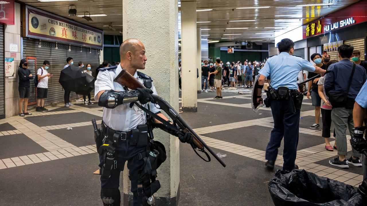 A riot police officer armed with a shotgun during protests in Hong Kong overnight. Picture: Getty Images