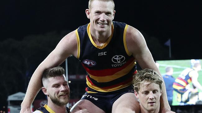 Adelaide’s Sam Jacobs gets chaired off in his 200th game against Collingwood by Bryce Gibbs and Rory Sloane. Picture SARAH REED.