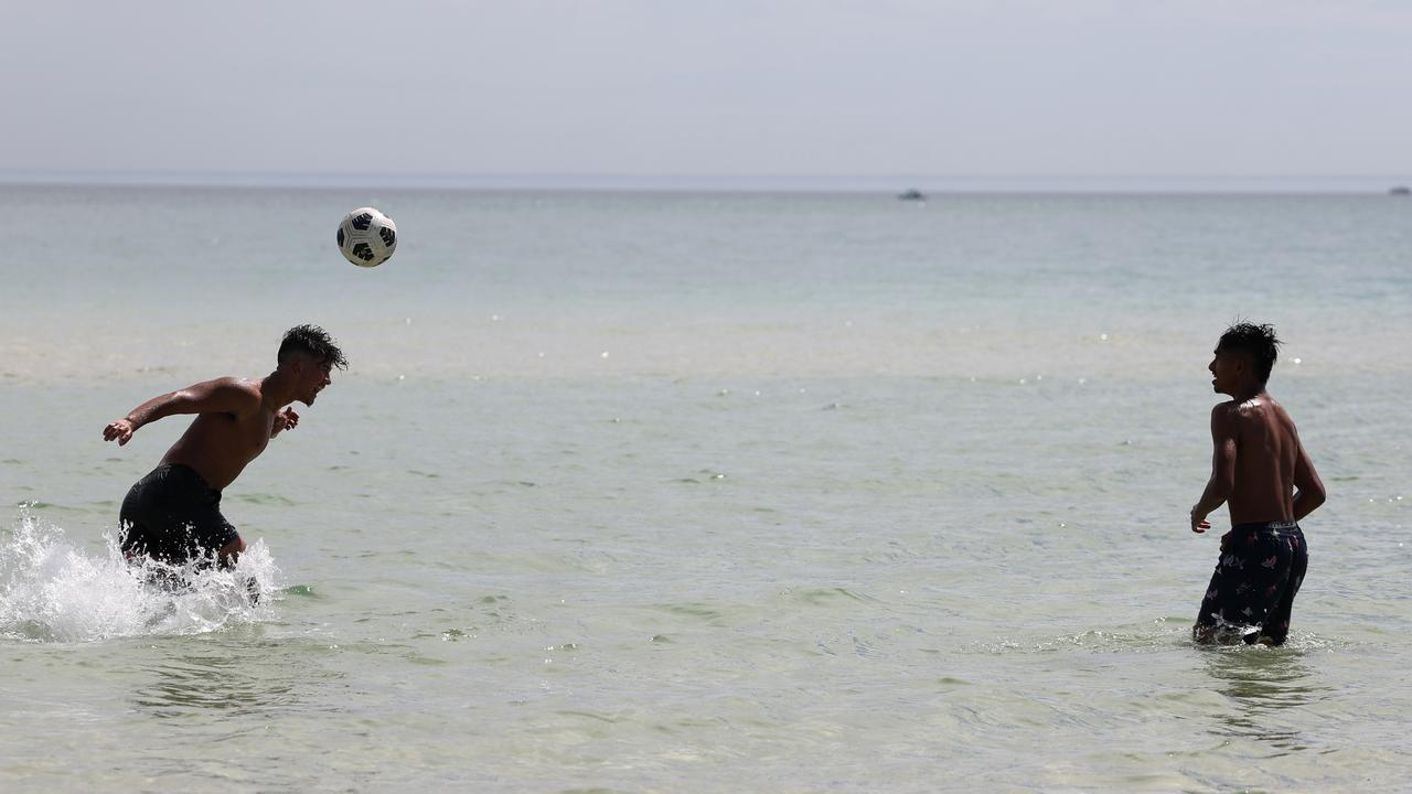 Beach-goers enjoy the water at West Beach on a hot day in Adelaide. NCA NewsWire / David Mariuz