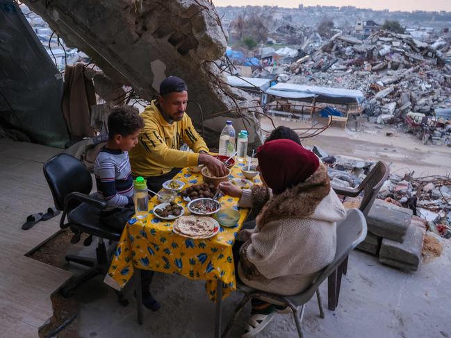 A Palestinian family breaks fast amid the rubble of Gaza before Israel cuts off electricity. Picture: AFP