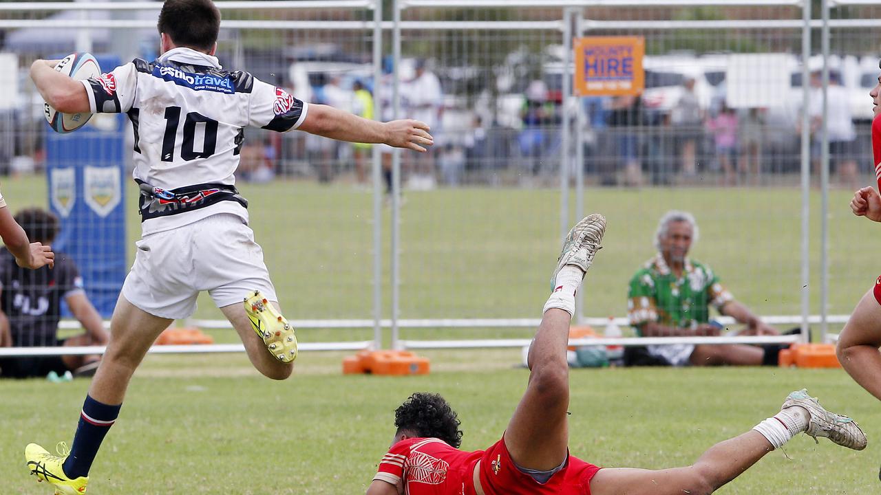 Barbarians' Lachlan Connolly escapes Tonga's Dennishely Taukafa in the U16s.