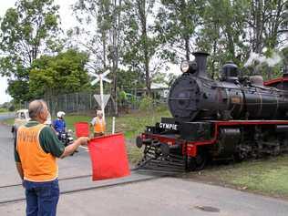 BLAST FROM THE PAST: Geoff Harvey (front) and Reg Lawler (rear) flagging the Rattler at Dagun railway station in previous years.