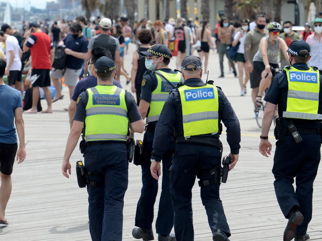 Police were out in force to manage the crowds at St Kilda beach. Picture: NCA NewsWire / Andrew Henshaw