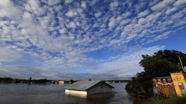 A submerged shed is seen on the bank of the overflowing Clarence River in Grafton. Photo: SAEED KHAN / AFP