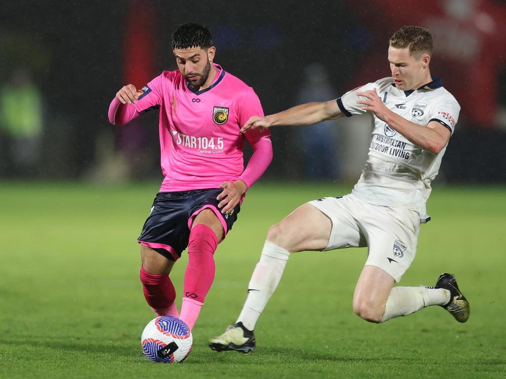 GOSFORD, AUSTRALIA - MAY 01: Christian Theoharous of the Mariners is tackled by Harry Van der Saag of Adelaide United during the A-League Men round 25 match between Central Coast Mariners and Adelaide United at Industree Group Stadium, on May 01, 2024, in Gosford, Australia. (Photo by Scott Gardiner/Getty Images) (Photo by Scott Gardiner/Getty Images)