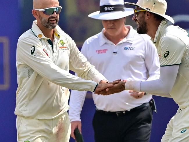 Australia's Nathan Lyon (L) celebrates with Mitchell Starc (R) after taking the wicket of Sri Lanka's Kusal Mendis during the fourth day of the first Test cricket match between Sri Lanka and Australia at the Galle International Cricket Stadium in Galle on February 1, 2025. (Photo by Ishara S. KODIKARA / AFP)