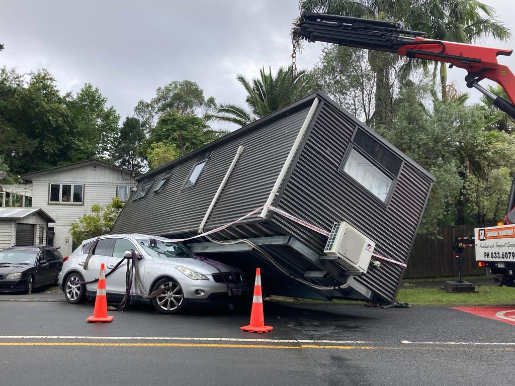 A granny flat is washed out on to a street in Auckland. Picture: Elizabeth Binning