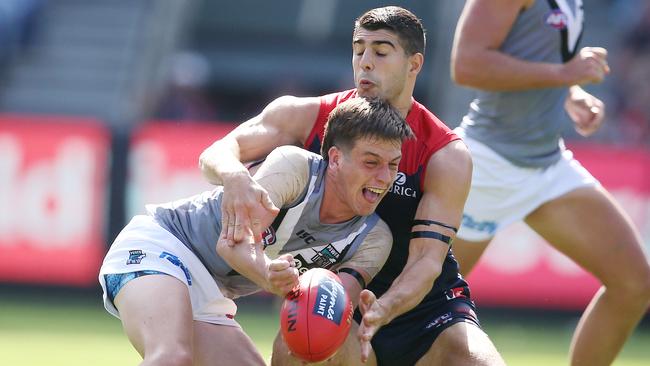 Zak Butters is tackled by Christian Petracca. Picture: Michael Klein.