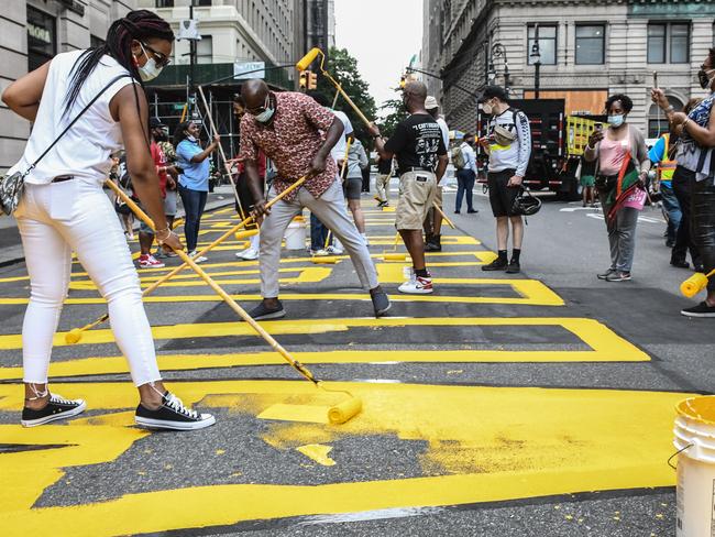 Workers paint a Black Lives Matter mural on the street in front of Brooklyn's Borough Hall. Picture: AFP