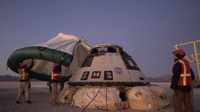 Boeing NASA, and US Army personnel inspect the Boeing Starliner spacecraft shortly after it landed in White Sands, New Mexico on February 7. Picture: AP