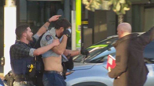 A police officer is seen covered in blood at the scene of the shooting. Picture: 1News