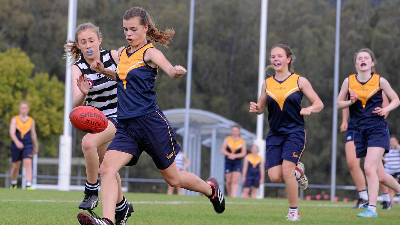 FINALS TIME: Fairholme's Evie Mason (left) punts the ball downfield with teammate Zoe Crooke in support. Fairholme will face Mountain Creek State High School in the semi-final of the AFLQ Schools Cup next week. Picture: Fairholme College