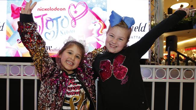 Ava Dasilva, 6, and Lily O'Donohoe, 8, pose for a photo in their JoJo bows. Picture: AAP/David Swift.