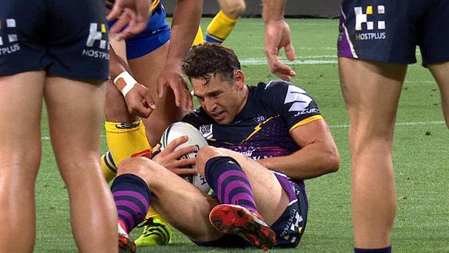 Billy Slater goes down on his left arm.