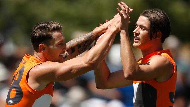 Daniel Lloyd (left) and Lachie Tiziani of the GWS Giants celebrate during the JLT Community Series win over West Coast. (Photo by Michael Willson/AFL Media/Getty Images)