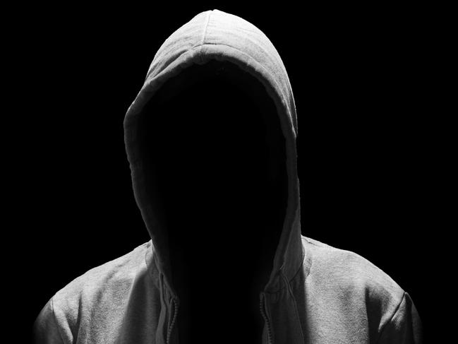 Portrait of Invisible man in the hood isolated on black background creep pervert molestor generic Photo: iStock