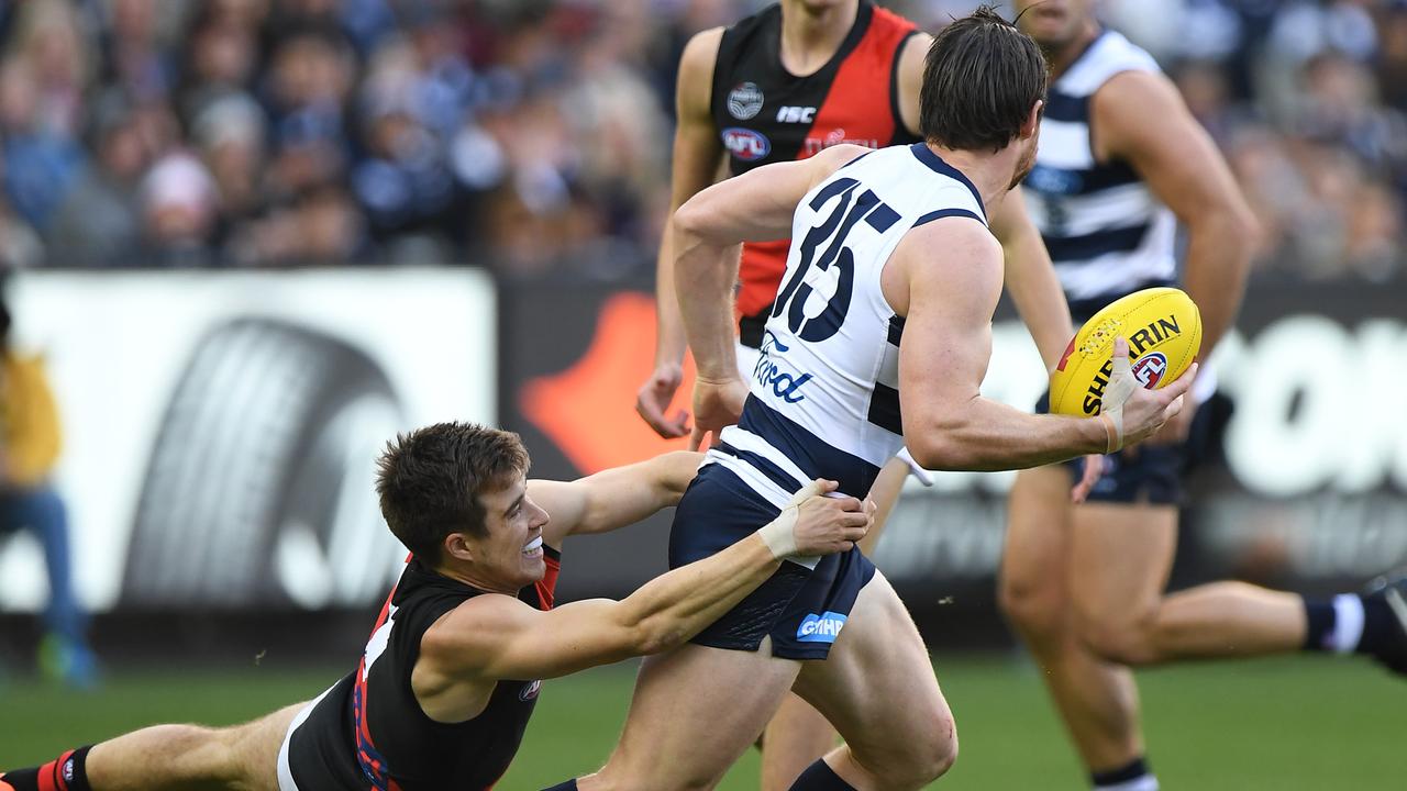 Zac Merrett tackles Patrick Dangerfield. Photo: Julian Smith/AAP Image. 