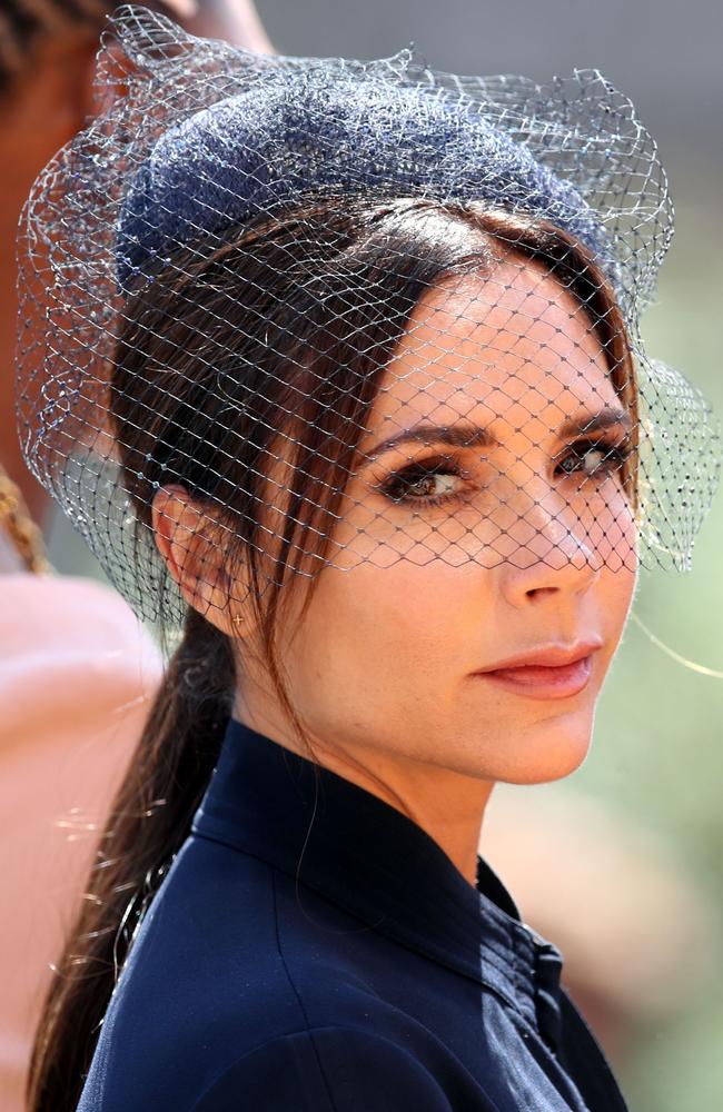 Victoria Beckham not quite smiling in her navy blue outfit. Picture: AFP/CHRIS RADBURN