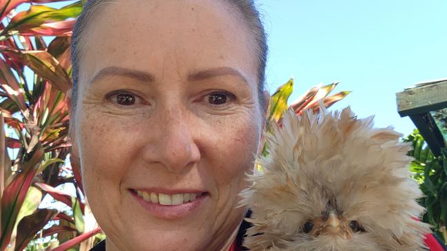 Owner of Moorland Cottage Cafe, Christina Jones with one of her many feathery friends who entice many visitors from near and far but the Mid Coast Council wants the prize-winning birds locked up despite community outcry.