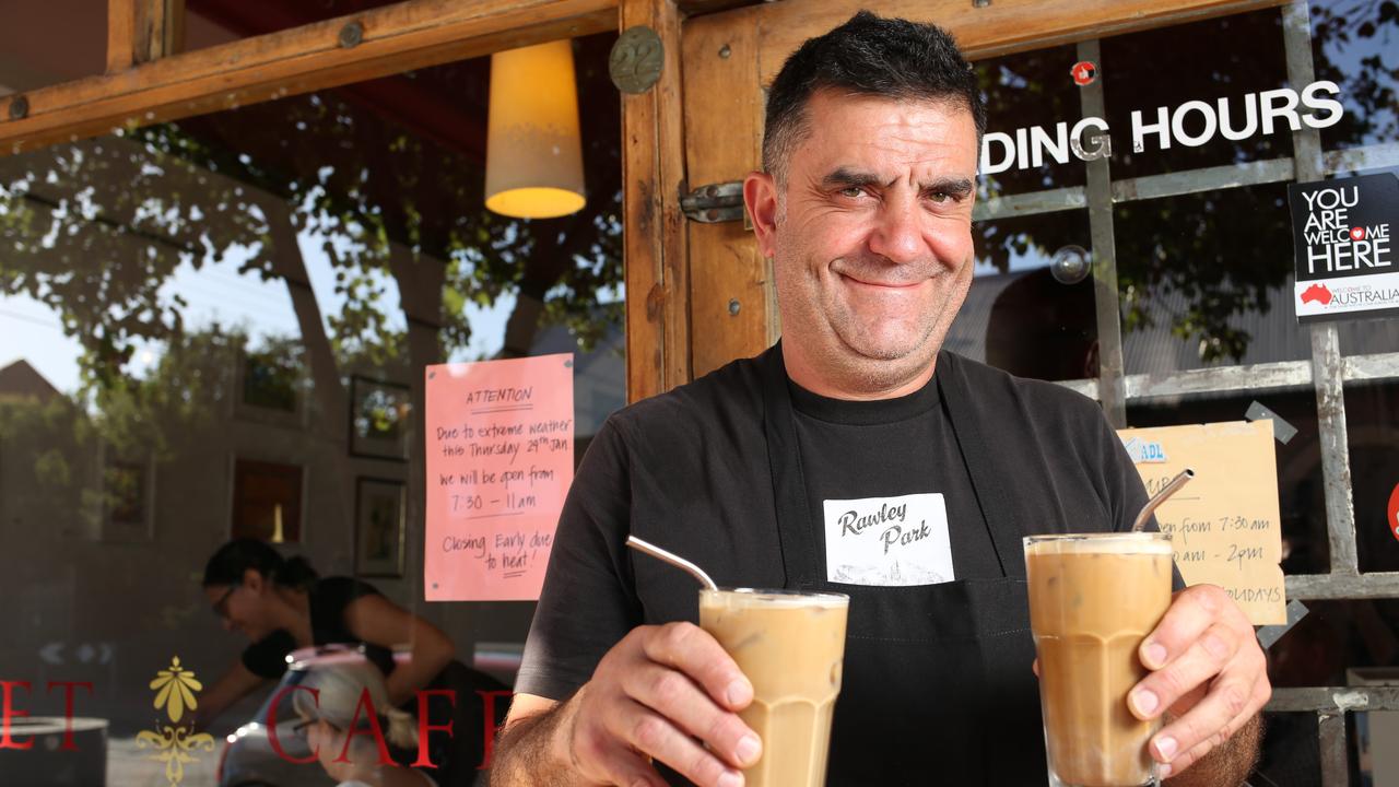 Brompton's Hawker Street Cafe manager Michael Tomljenovic serving iced coffee to his customers before shutting up amid the intense heat. Picture: AAP image/Emma Brasier