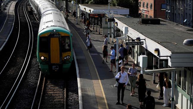 Commuters wait for their train on a platform at West Norwood station in south London on amid disruption warnings over extreme heat. Picture: AFP