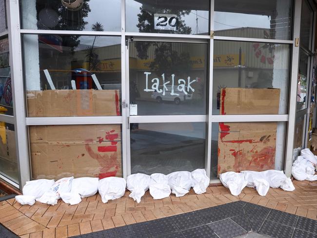 A row of sandbags cover the front of a shop in the town of Lismore on March 5, 2025. Picture: David Gray/AFP