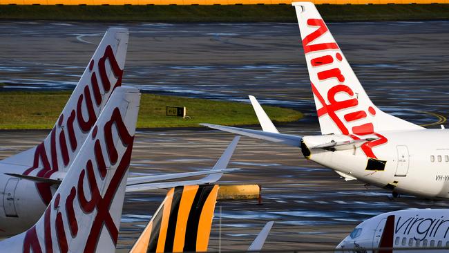 Planes from Australian airlines Tiger Air and Virgin sit idle on the tarmac at Melbourne's Tullamarine Airport. Picture: AFP