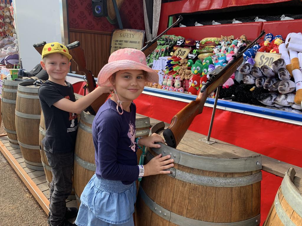 (L) Finn Ammenhauser and Veronica van der Merwe take aim at the air rifle range at the Fraser Coast Ag Show for 2021. Photo: Stuart Fast