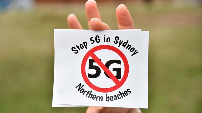 Anti 5G sticker being held by a member of Stop 5G Northern Beaches group. Picture: Troy Snook.