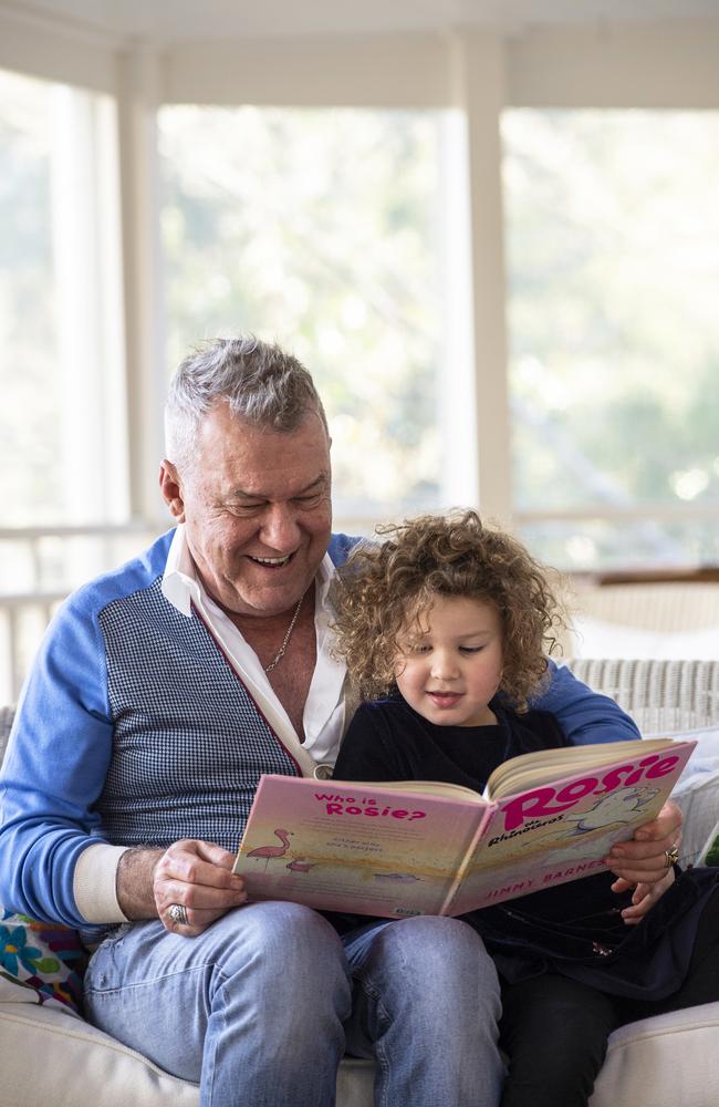 Jimmy Barnes reads his new kids' storybook Rosie The Rhinoceros with granddaughter Rosie. Picture: Supplied