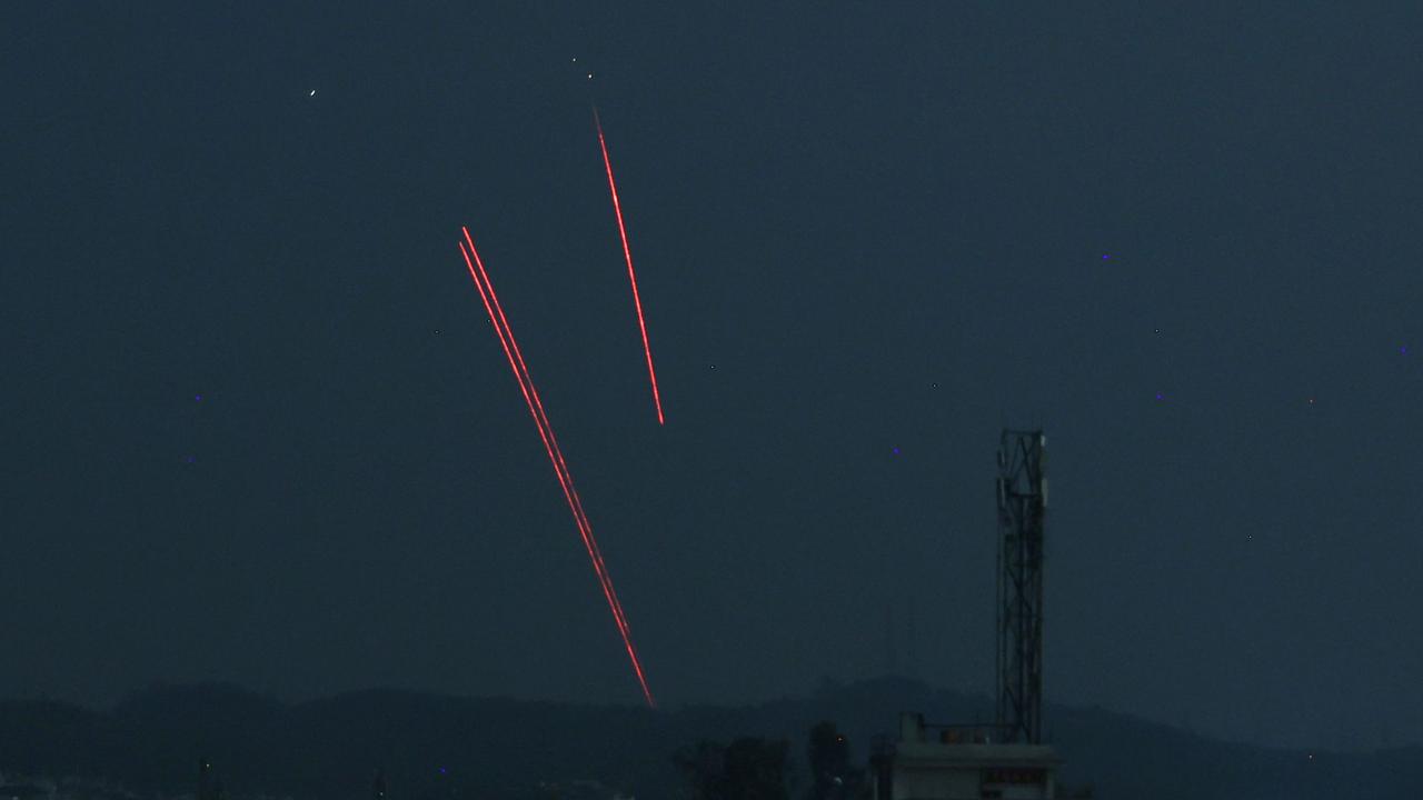 Trails from an Indian air defence system are seen above Jammu during a Pakistani strike. (Photo by Rakesh BAKSHI / AFP)