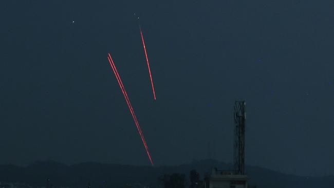 Trails from an Indian air defence system are seen above Jammu during a Pakistani strike. (Photo by Rakesh BAKSHI / AFP)