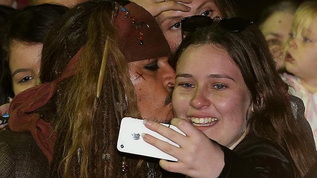 Hollywood actor Johnny Depp kisses a fan who waited several hours to see him at The Spit after filming of the Pirates of the Caribbean, Gold Coast. Picture: Regi Varghese