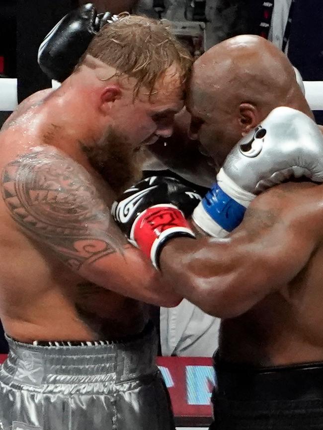 The two men embraced after the fight. (Photo by TIMOTHY A. CLARY / AFP)