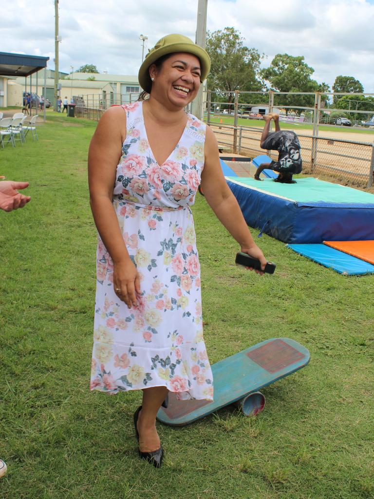 Abigail Andersson trying her best to master the wobble board in high heels at the Murgon Show. Photo: Laura Blackmore