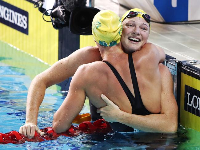 Cate Campbell, who has already won three gold medals this Commonwealth Games,  congratulates sister Bronte following her upset win in the women’s 100 metres freestyle. Picture: Hannah Peters/Getty Images