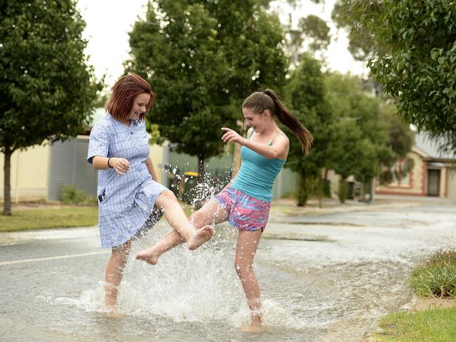 Monti Flora and Chelsee-Ann Russell make the most of the flooded roads at Campbelltown. Picture: Bianca De Marchi