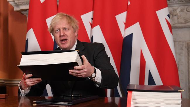 Boris Johnson prepares to sign the Brexit trade deal in 10 Downing Street on Thursday. Picture: Getty Images