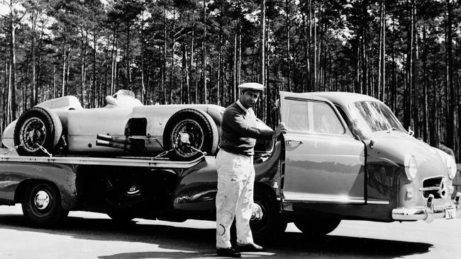 Argentine driver Juan Manuel Fangio with the Mercedes-Benz W-196R on a transporter ready for testing at the German Hockenheim Circuit in 1955.