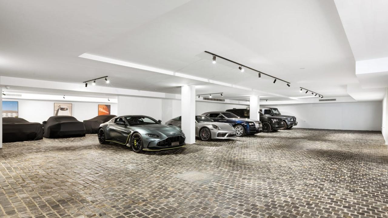 The 16-car garage with gallery lighting and glass walls.