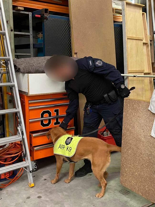 A police dog helps in the search at the warehouse.