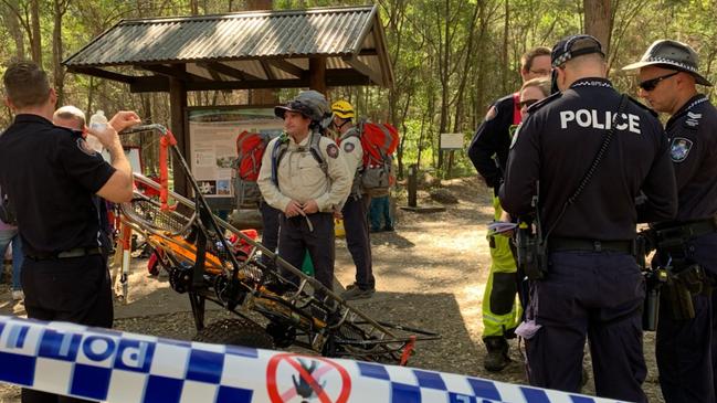 Emergency services at the base of Mt Ngungun where a young man fell to his death.