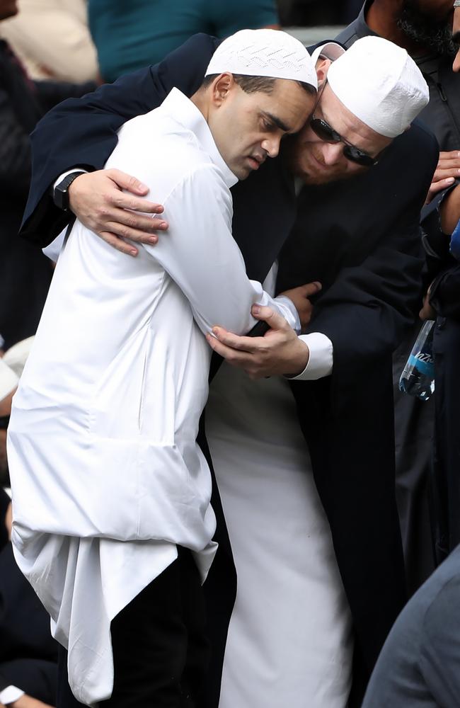 A young man is given support during a mass prayer that took place opposite the Al Noor Mosque, in Christchurch. Picture: Gary Ramage