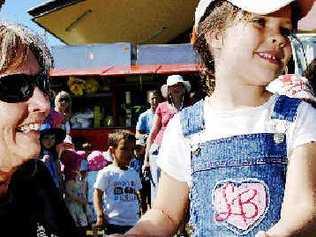 Eileen Wilton from the Lennox Head Rural Fire Service shows Sarah Mallam, 5, of Ballina the fire hose used by RFS crews.