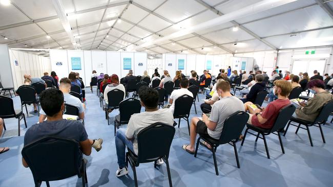 People wait to be vaccinated at a Covid-19 vaccination hub on the Gold Coast. Picture: NCA NewsWire /Jono Searle